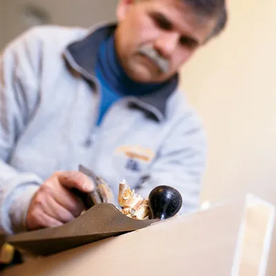 Tom Silva shaves down the side of a sticking door.