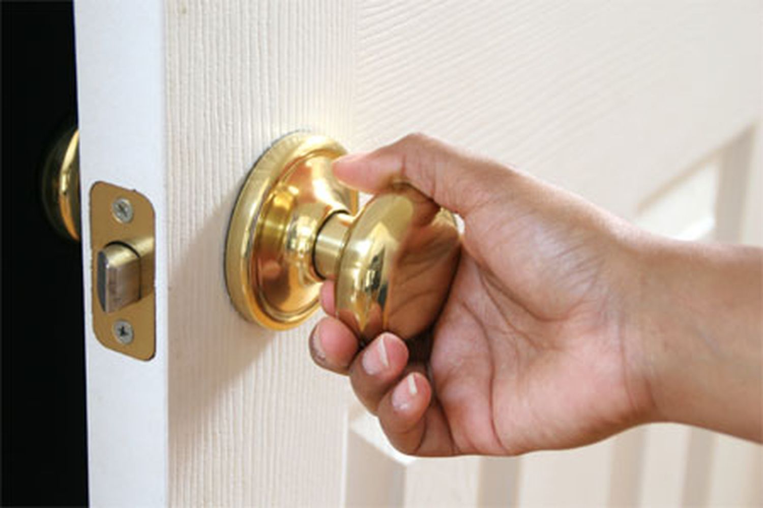 A person opens a sticking door.