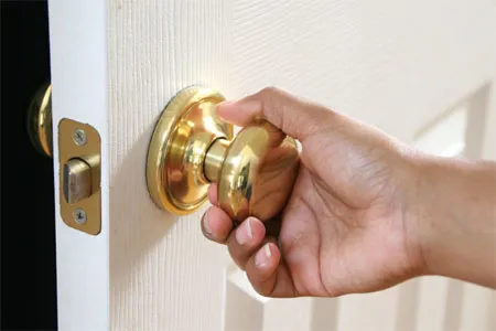 A person opens a sticking door.