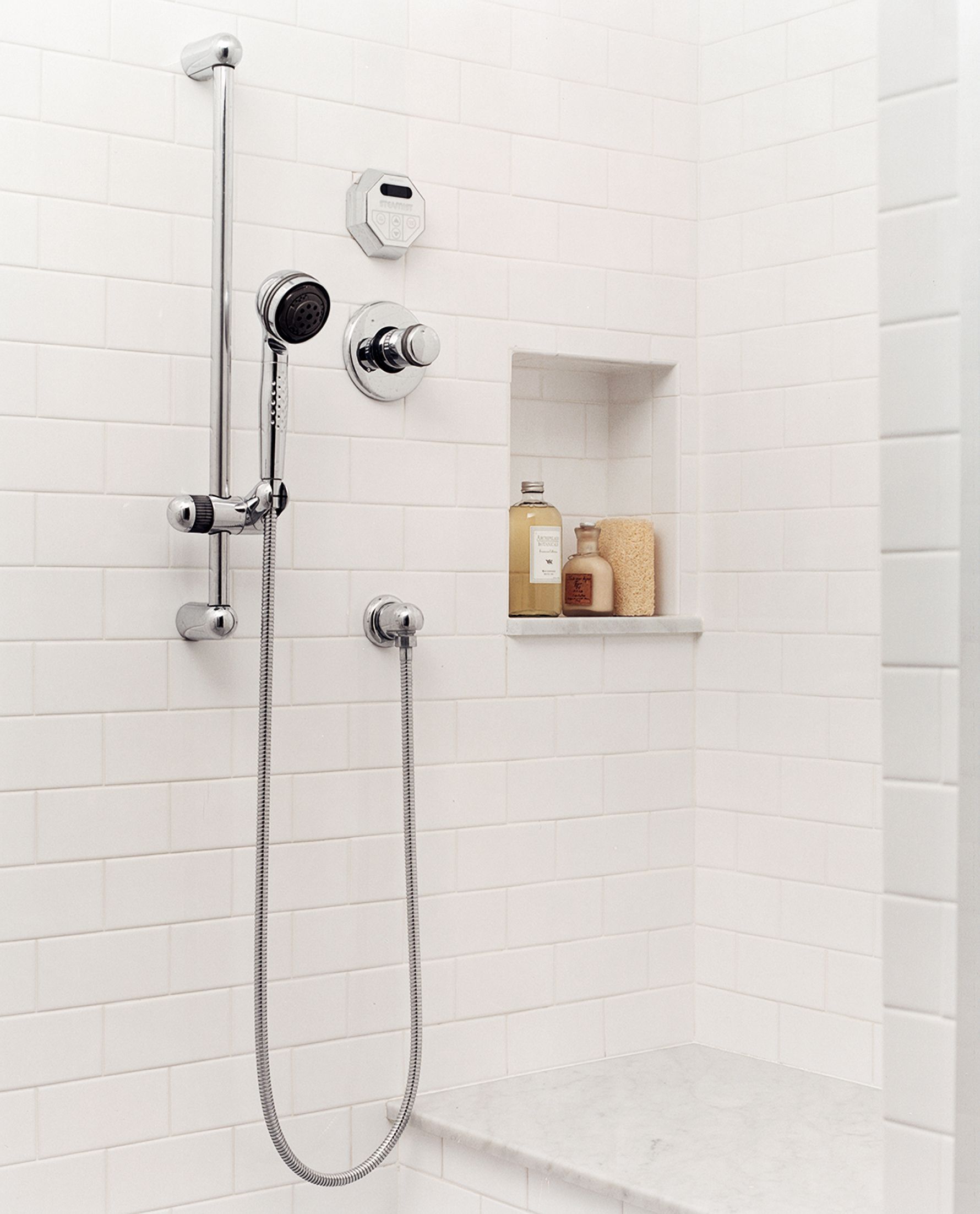 A shower updated with a niche and a bench.