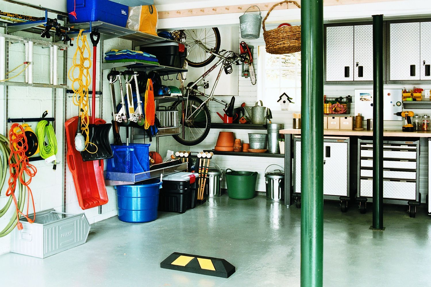 A garage with various storage bins and shelves.