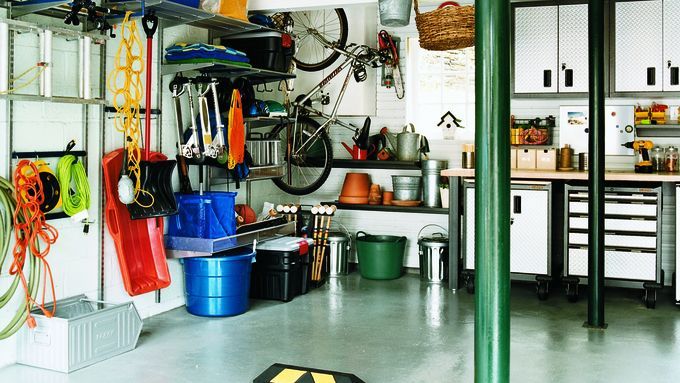 A garage with various storage bins and shelves.