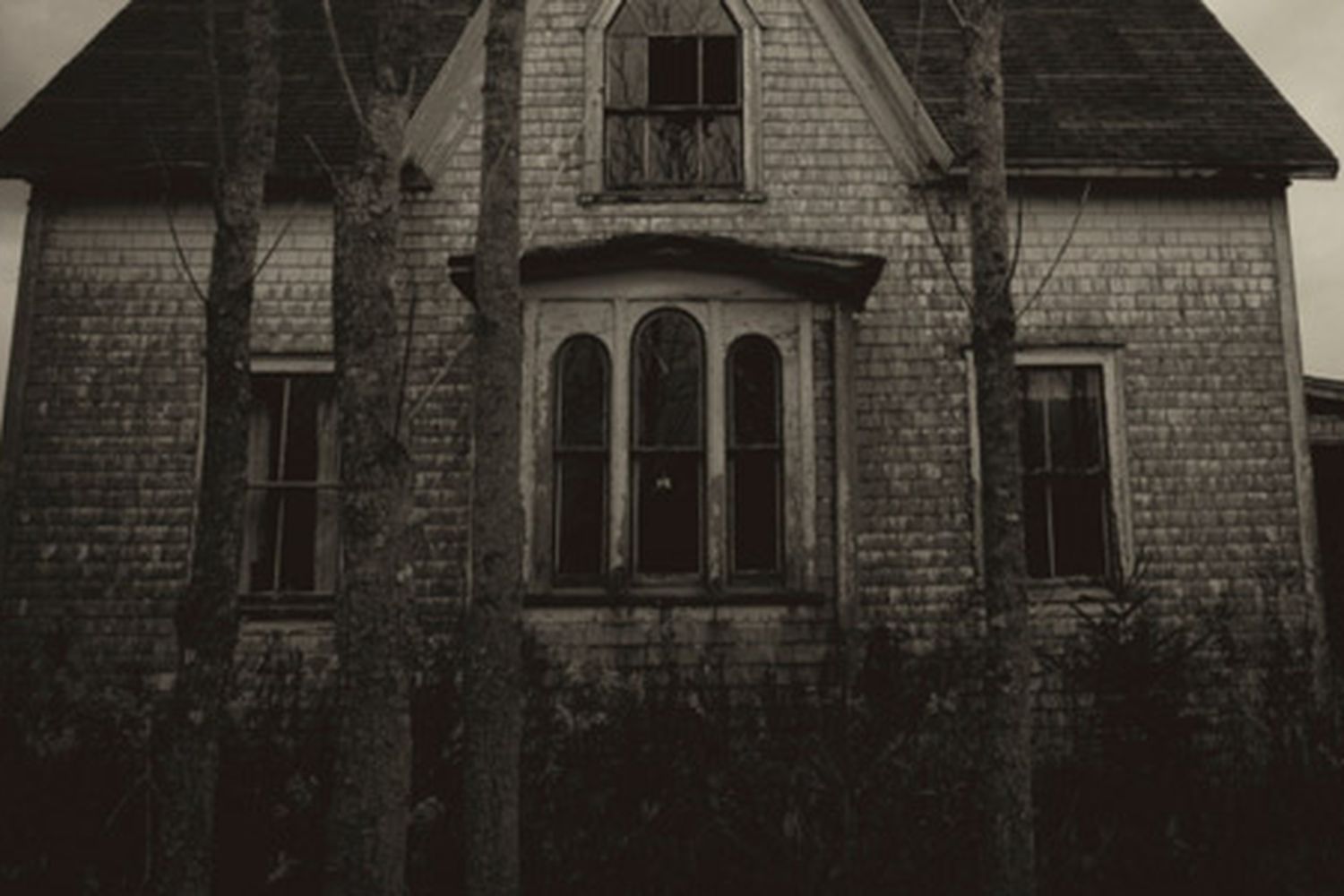 A haunted house in creepy gray lighting.