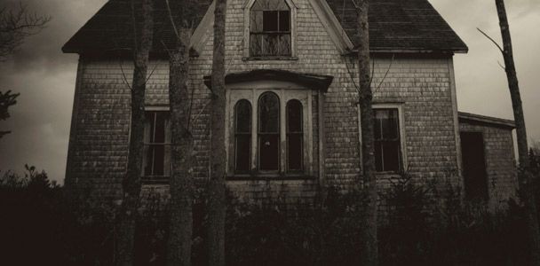 A haunted house in creepy gray lighting.