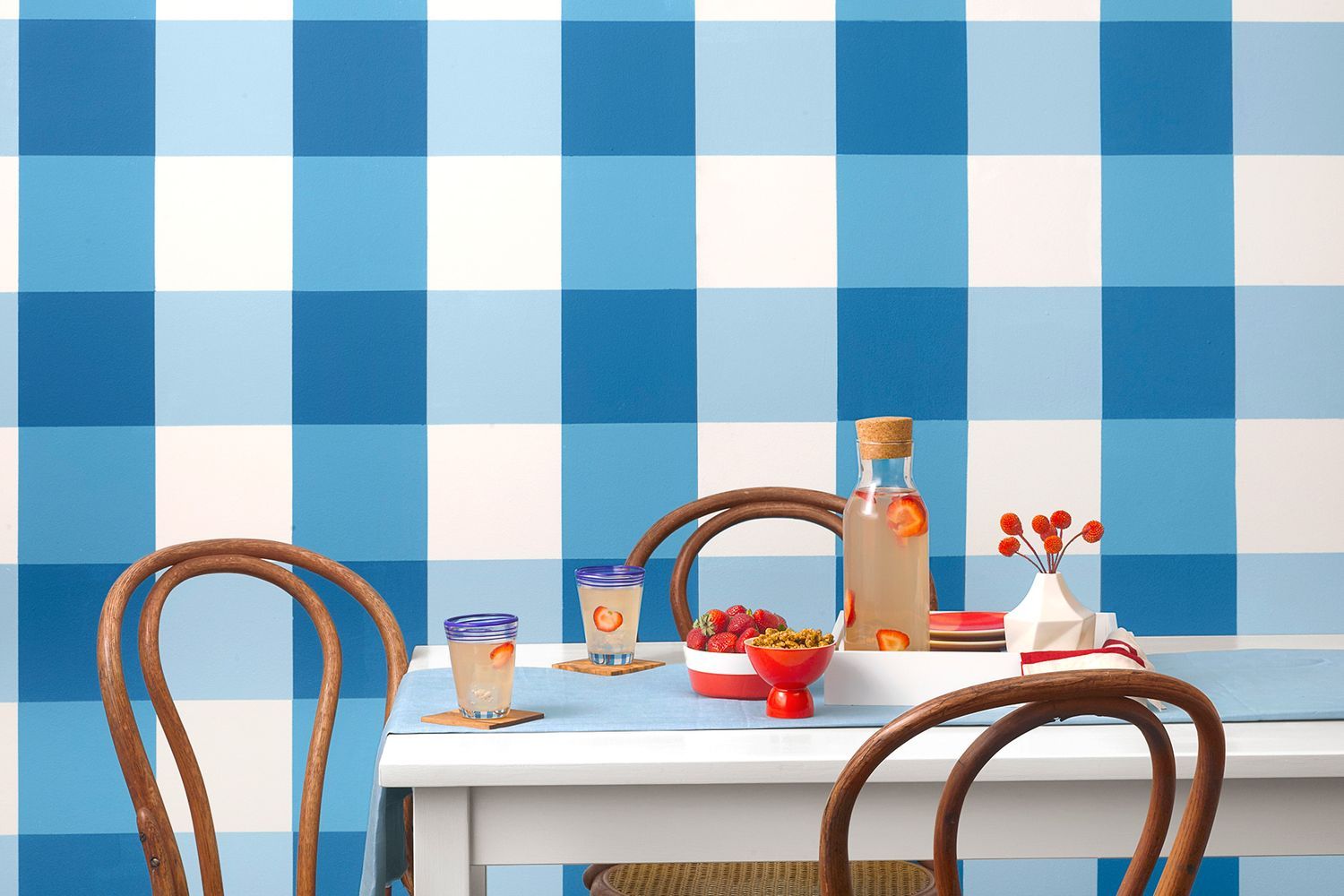 Dining room with gingham pattern checks painted on the wall.