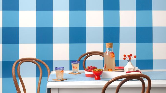 Dining room with gingham pattern checks painted on the wall.