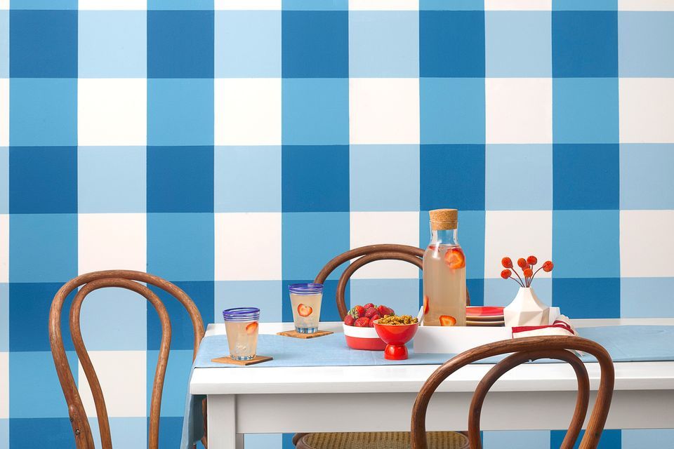 Dining room with gingham pattern checks painted on the wall.
