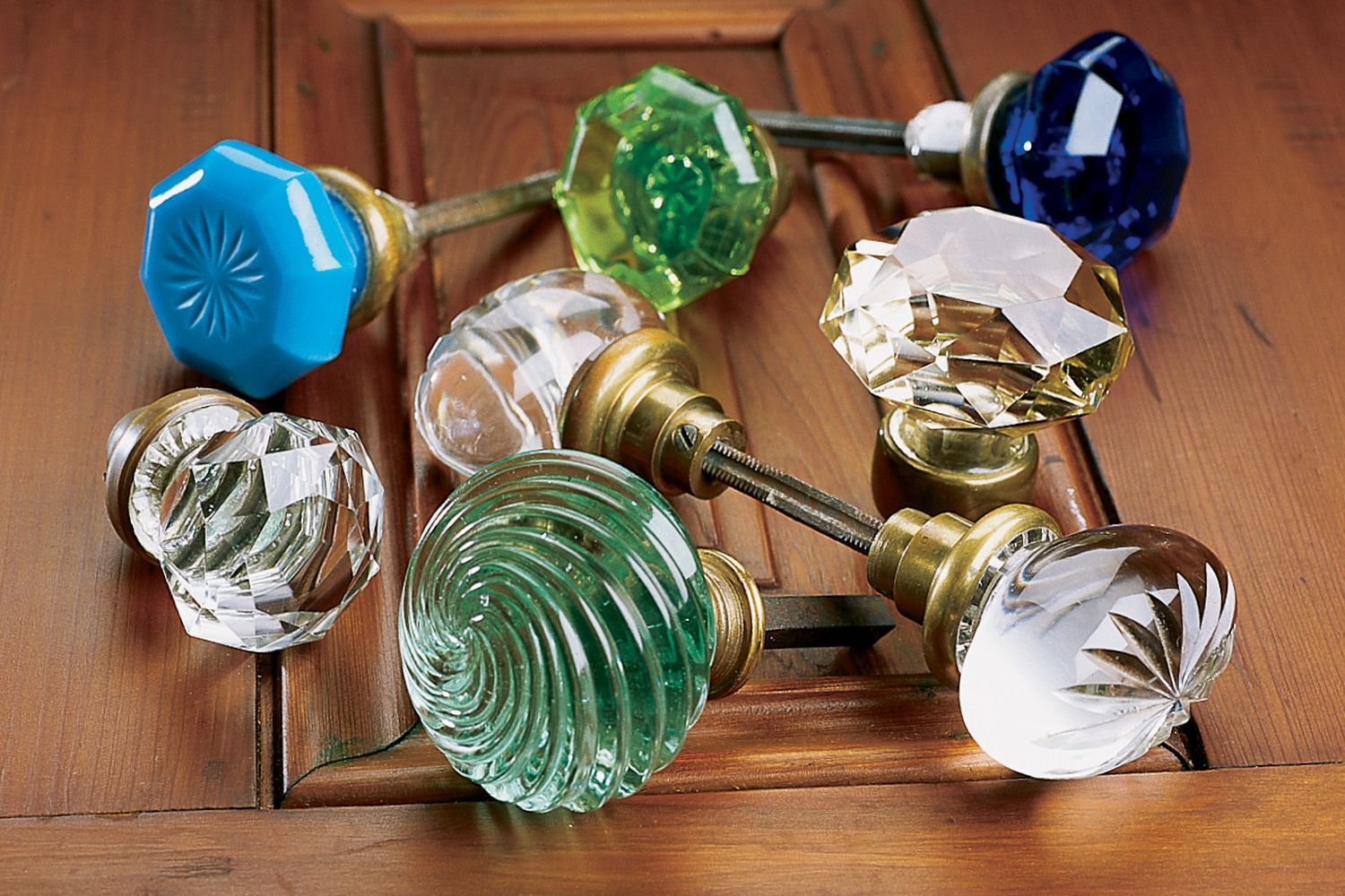 A variety of colorful glass doorknobs.