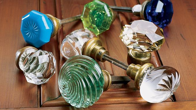 A variety of colorful glass doorknobs.