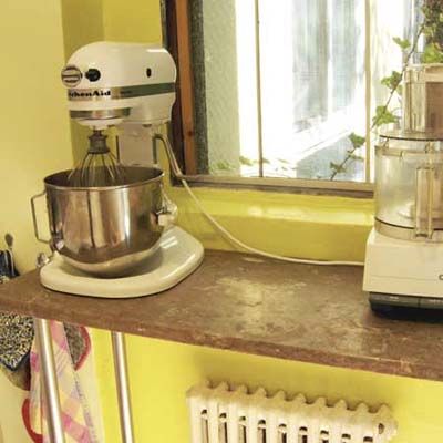 A mixer on a window shelf.