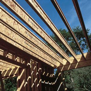 Framed house structure under construction with engineered I-joists forming part of the roof.