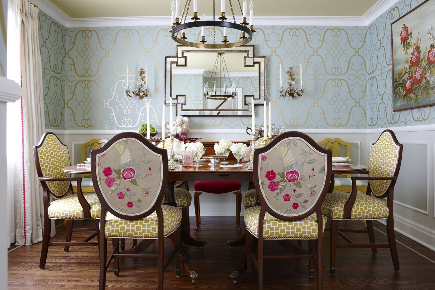 A jewel-box dining room with a table and shield back chairs.