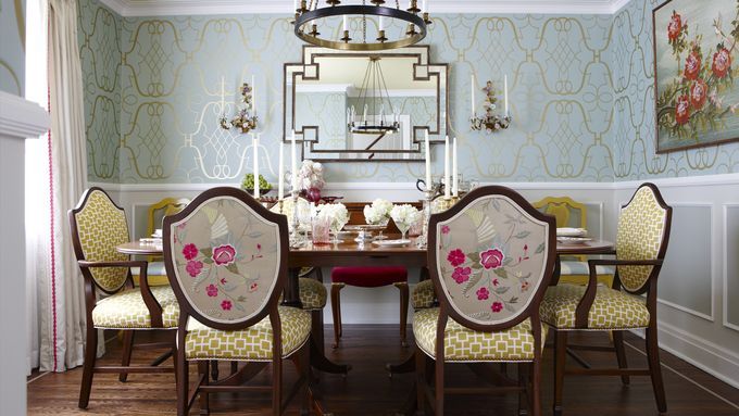 A jewel-box dining room with a table and shield back chairs.