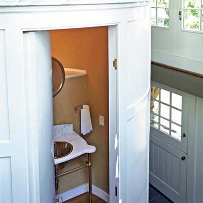 A small half bath separated from the foyer by a pocket door.