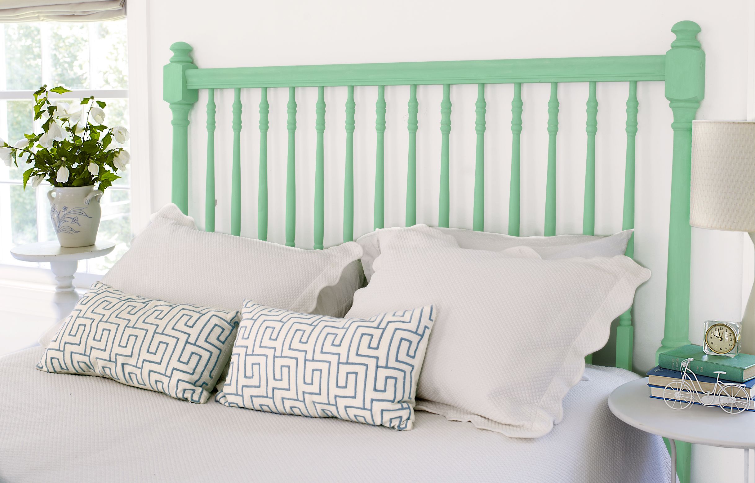 A bed with a DIY spindle headboard.