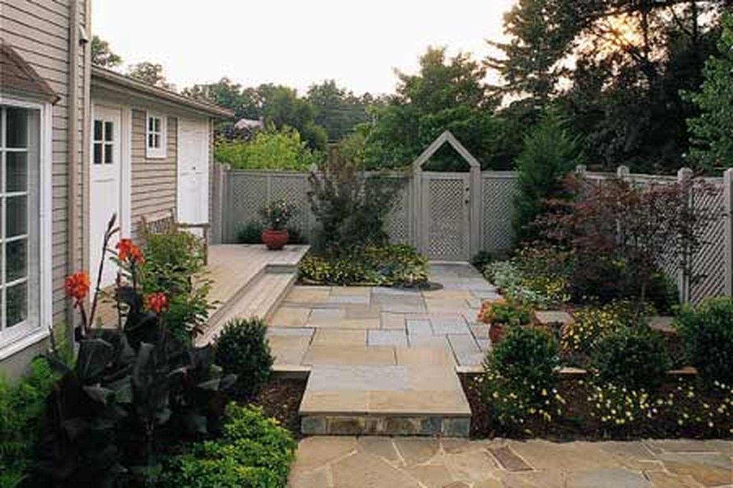 a backyard with privacy plants and fencing