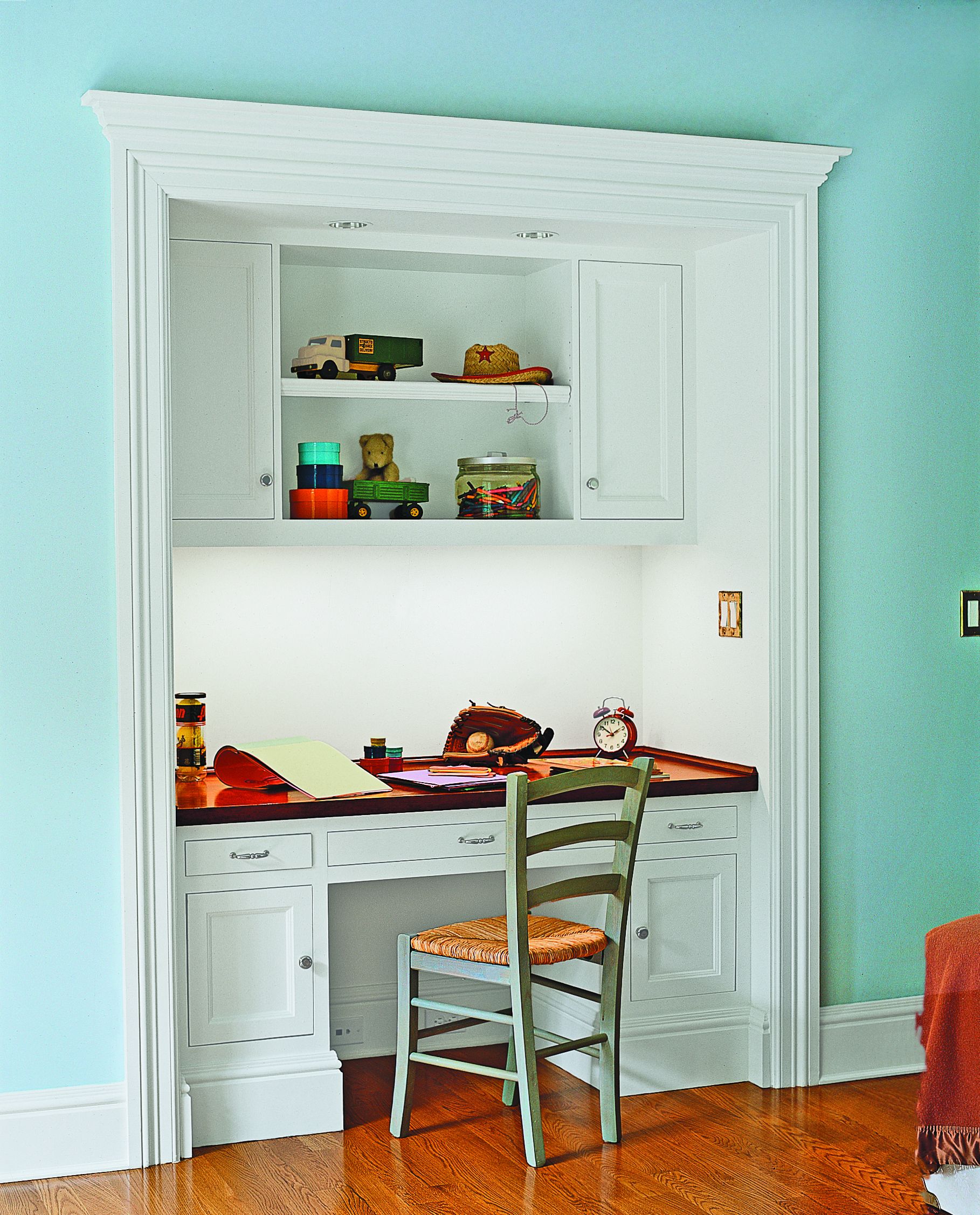 An alcove above a desk for storing items.