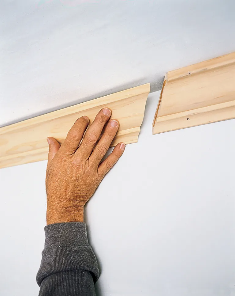 Hand placing crown molding