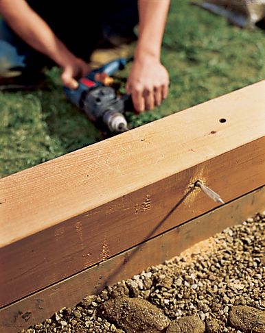 A man drills weep holes.