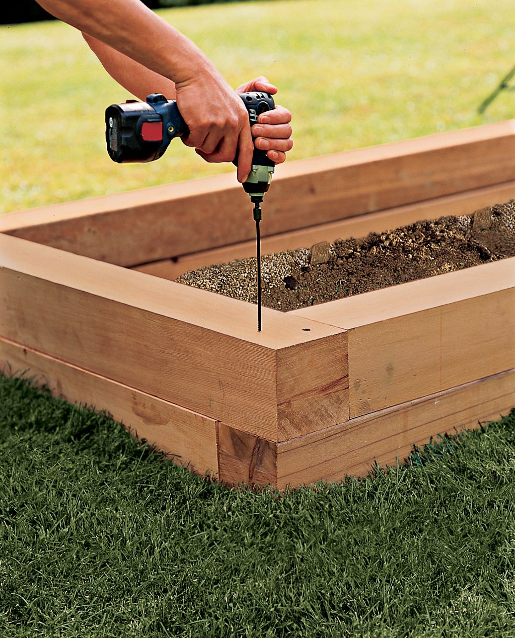 A man assembles the bed's walls.