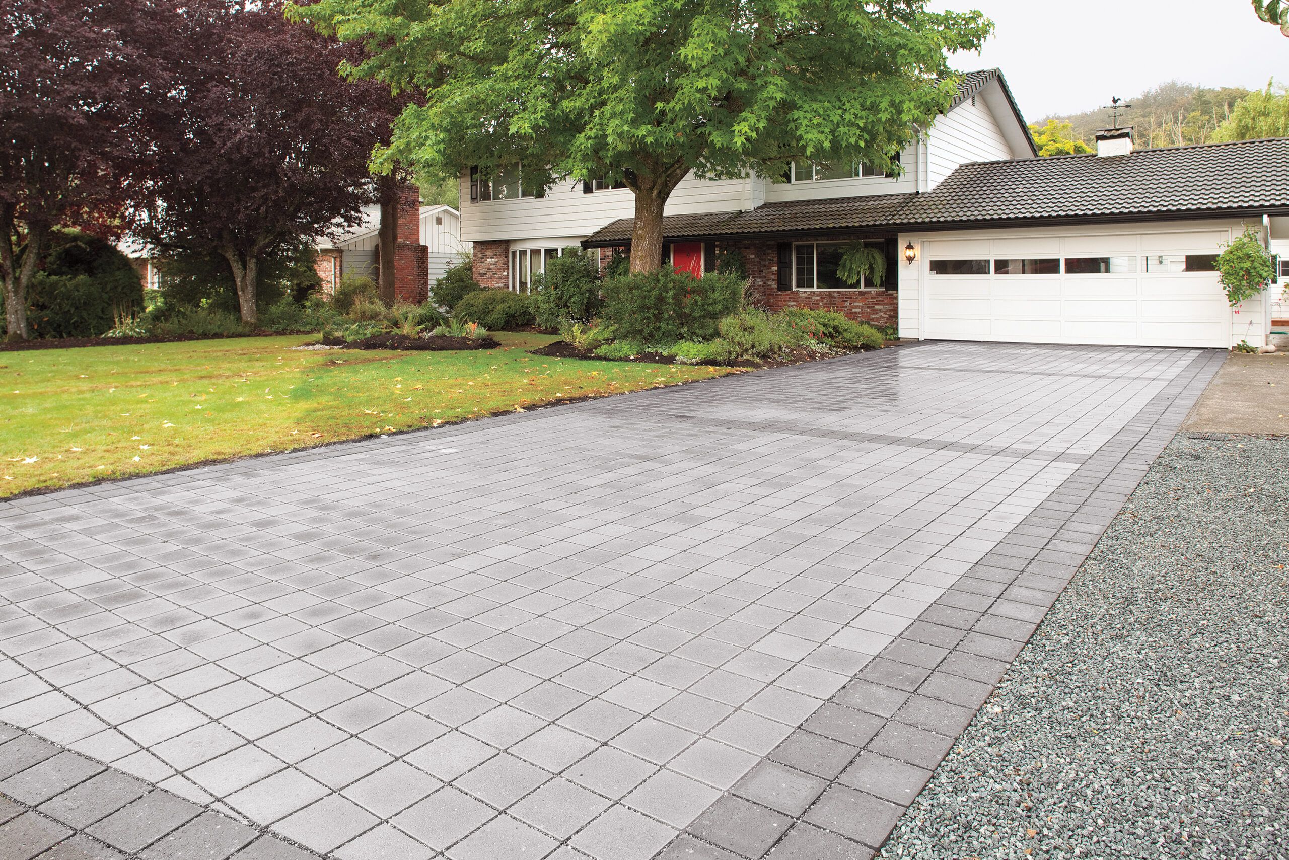 A DIY Stone driveway leading up to the garage of a home