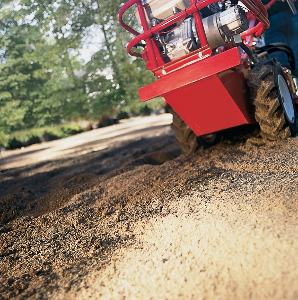 Machine adding sand to the soil.