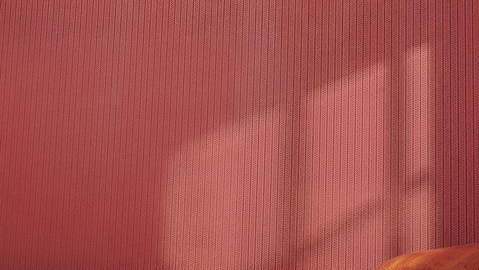 Red patterned wallpaper hanging on the wall of a room.