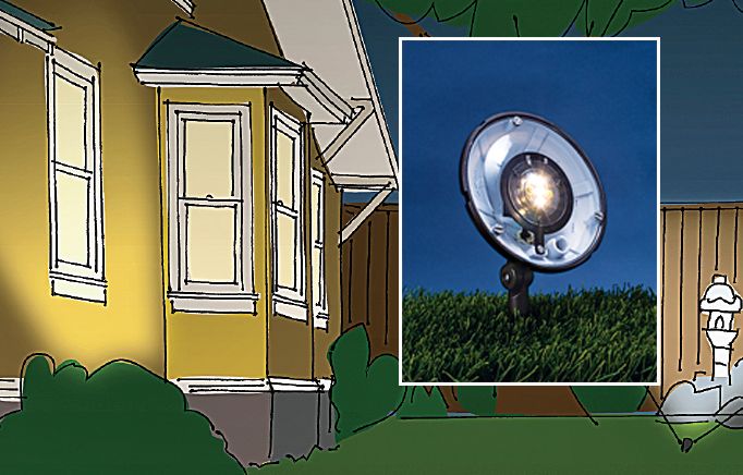 A drawing of a wash light, which is a round light fixture, shining onto the side of a yellow house.