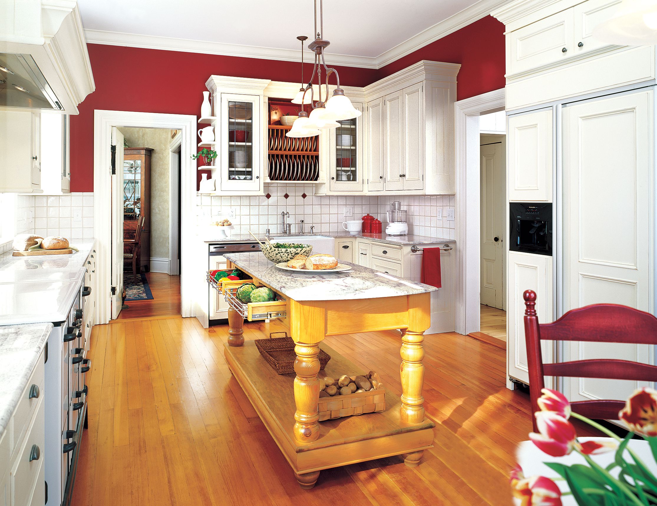 A kitchen island with cabinets full of food.