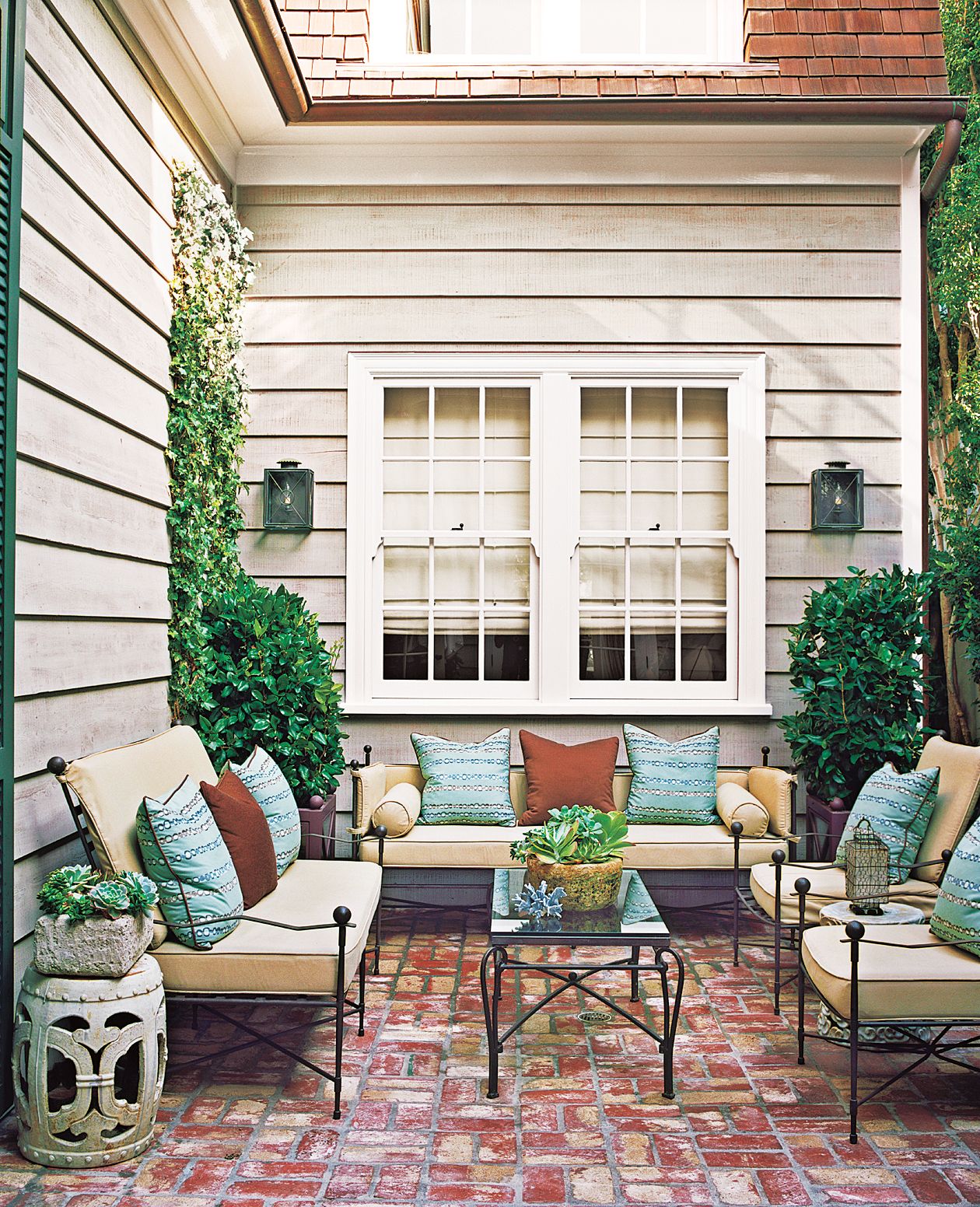 A mortared brick patio with a small seating area.