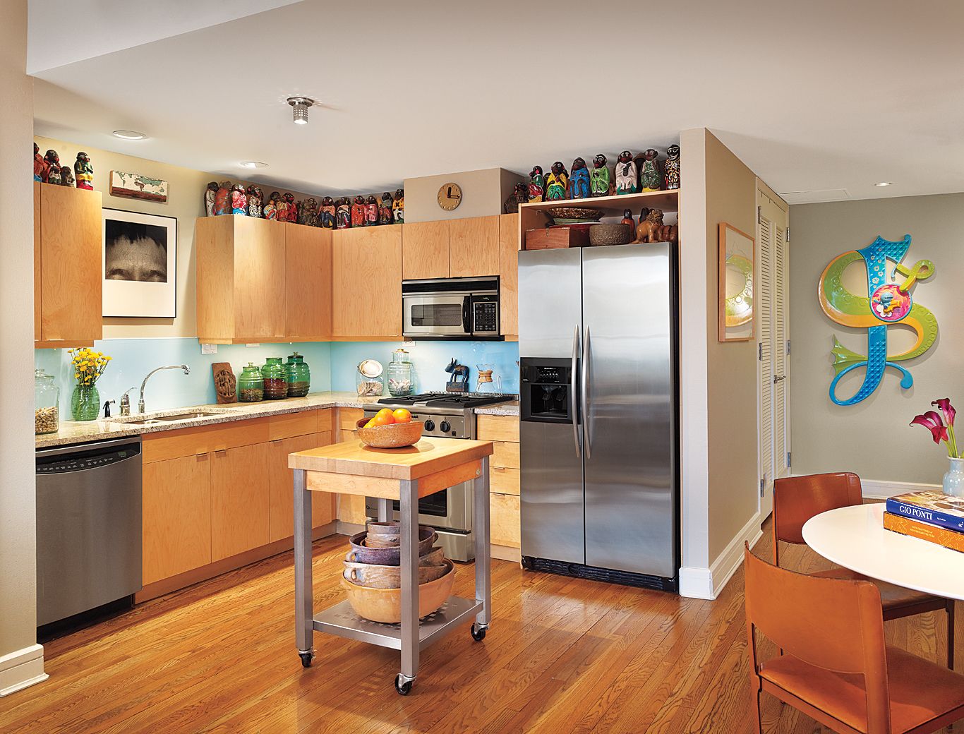 A kitchen island on wheels in a kitchen.