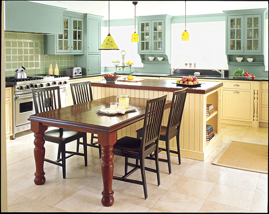 A kitchen island with light fixtures hanging over it.