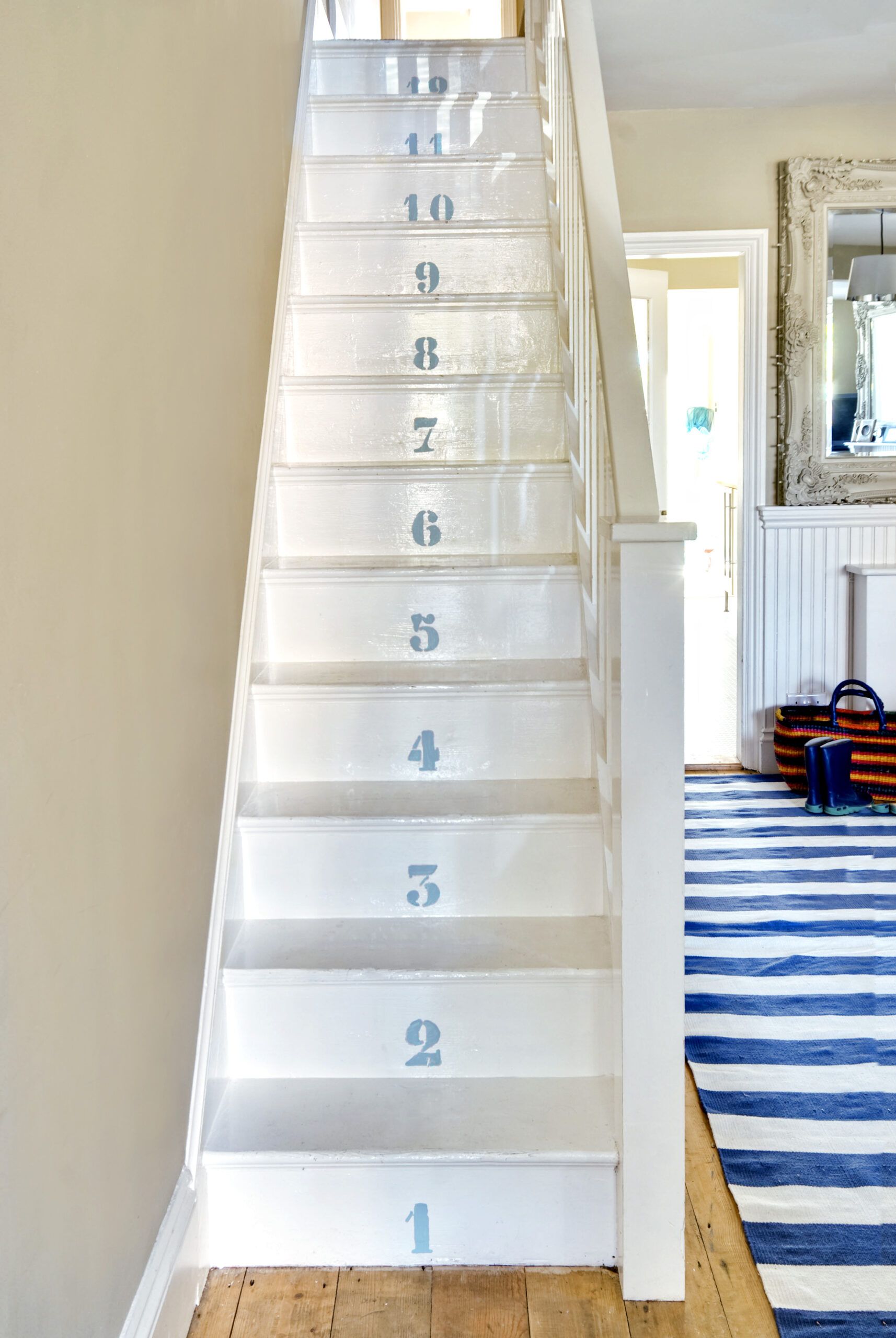 painted numbers on the stairs to represent a cottage-style interior of a home