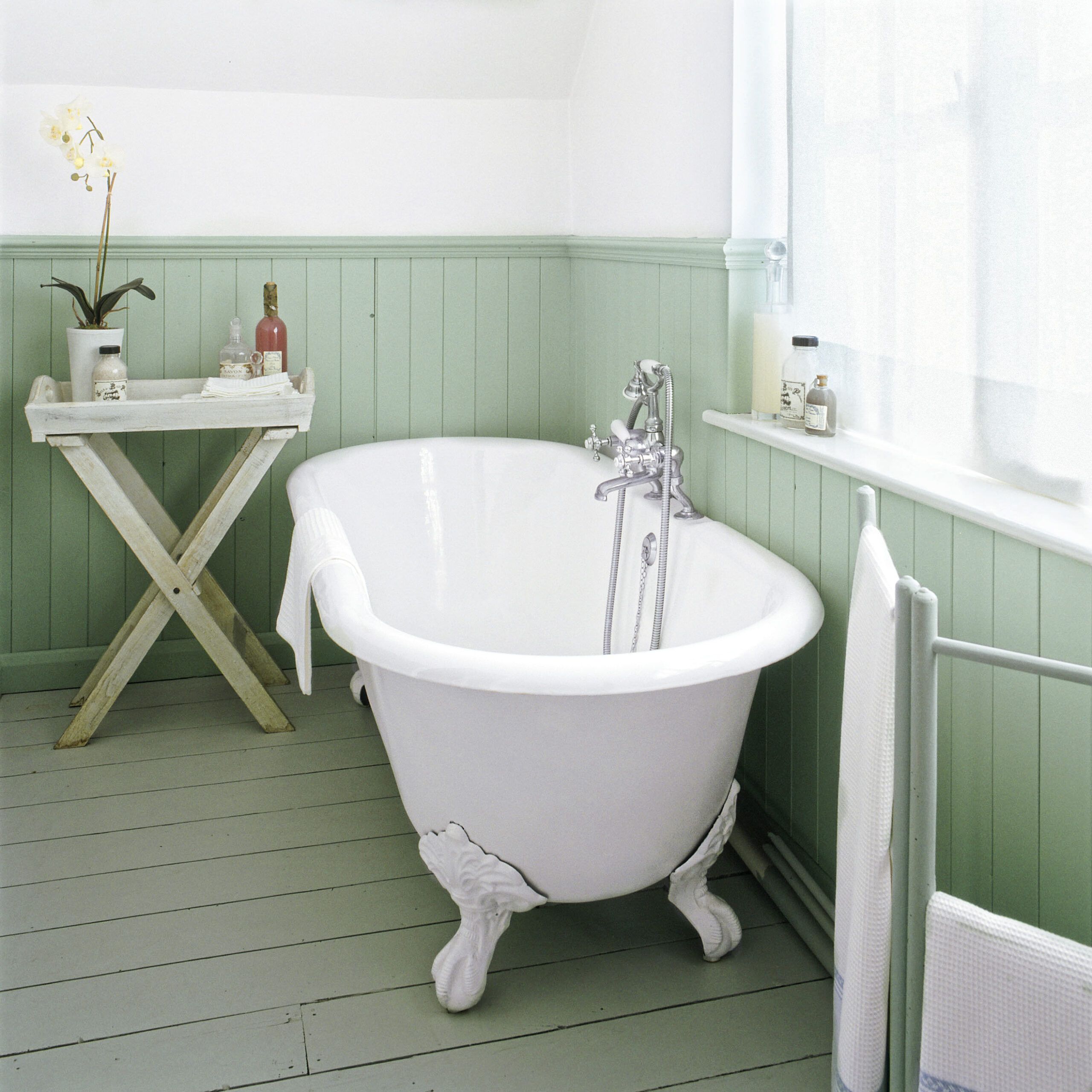 wood floors that are painted green to represent a cottage-style interior of a home