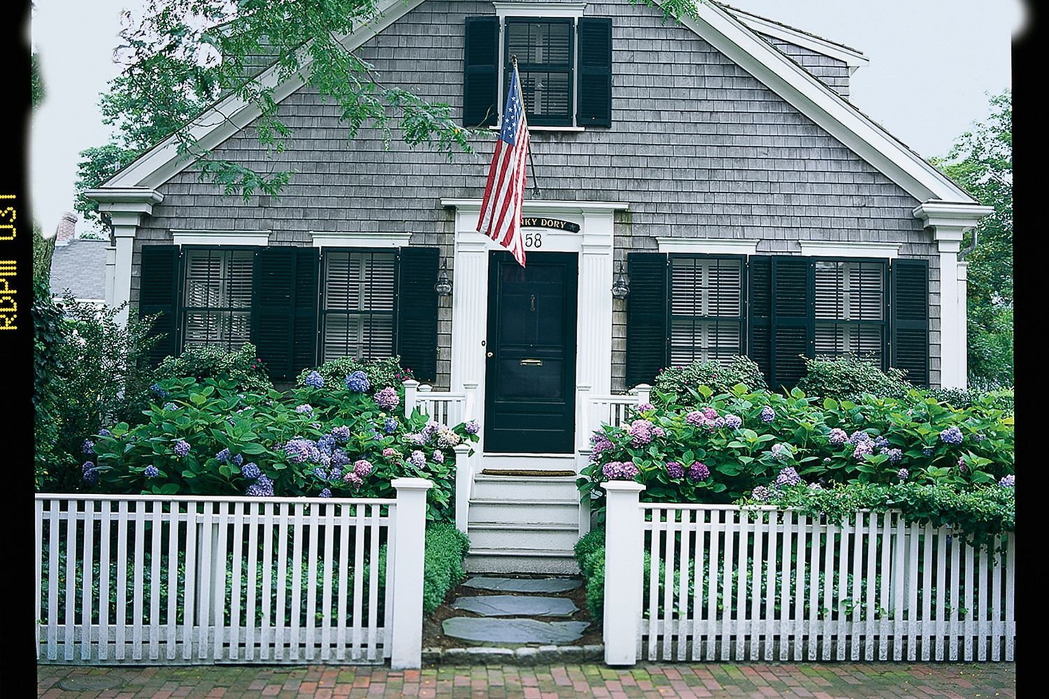 Flag pole installed in front of a home