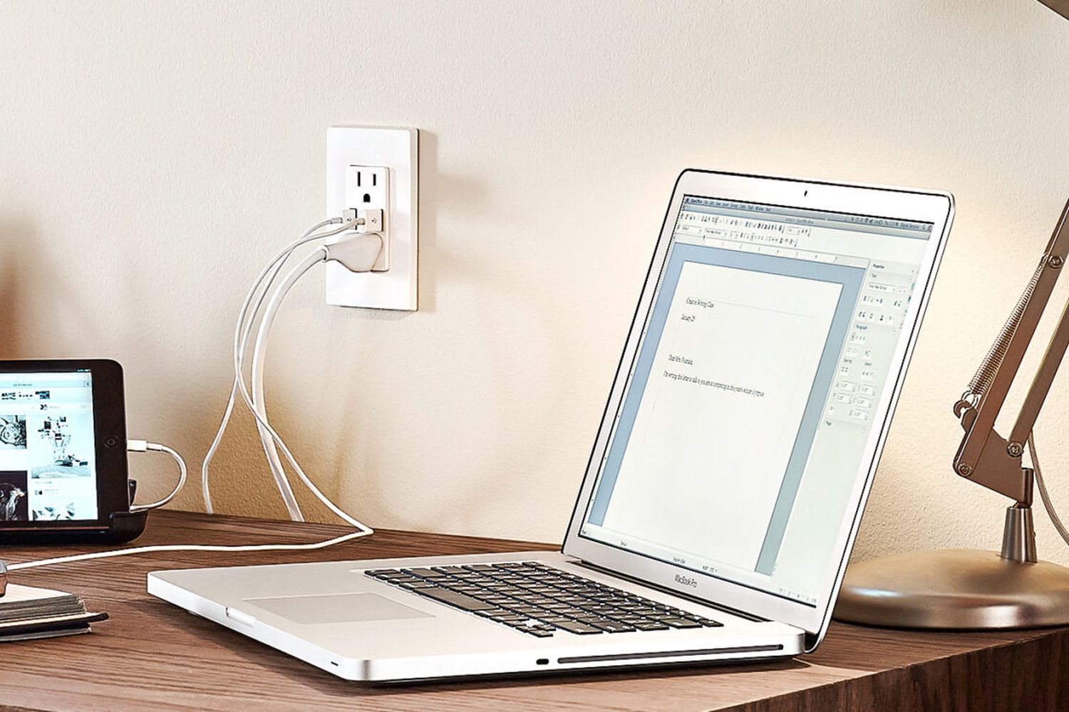 An outlet with a USB charging port near a desk.