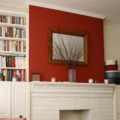 A red accent wall adds interest to a small space.