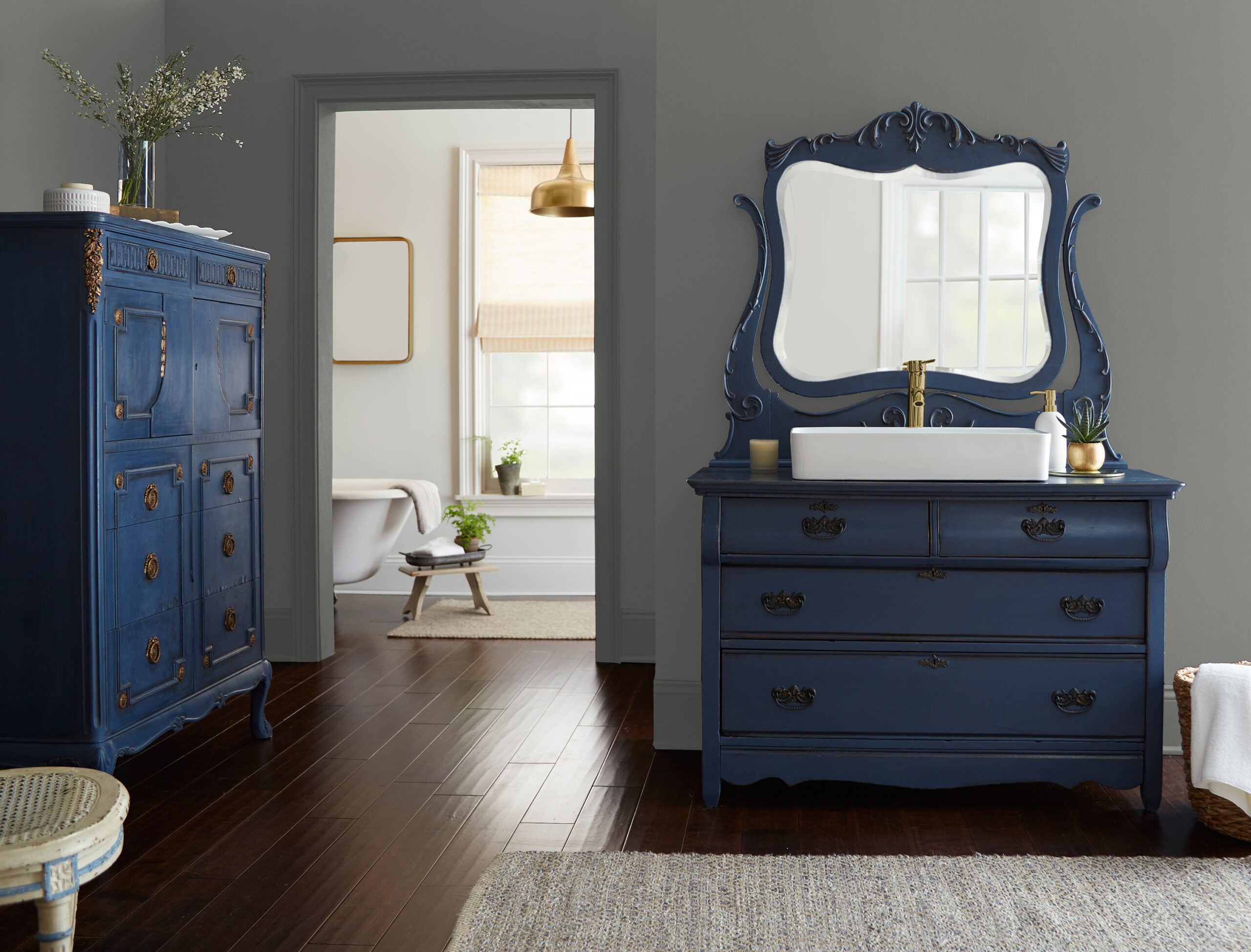 Bedroom with blue chest of drawers and vanity