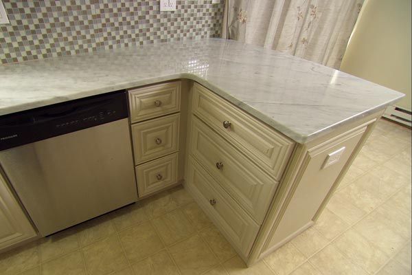 A creative corner is built by adding cabinets as a part of the budget-friendly kitchen makeover.