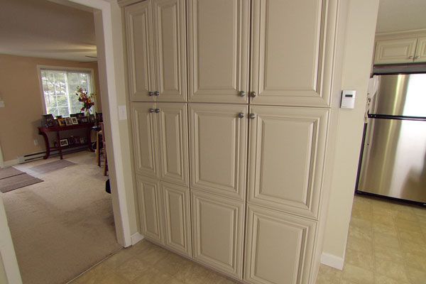 A floor-to-ceiling pantry unit in the budget-friendly makeover kitchen.