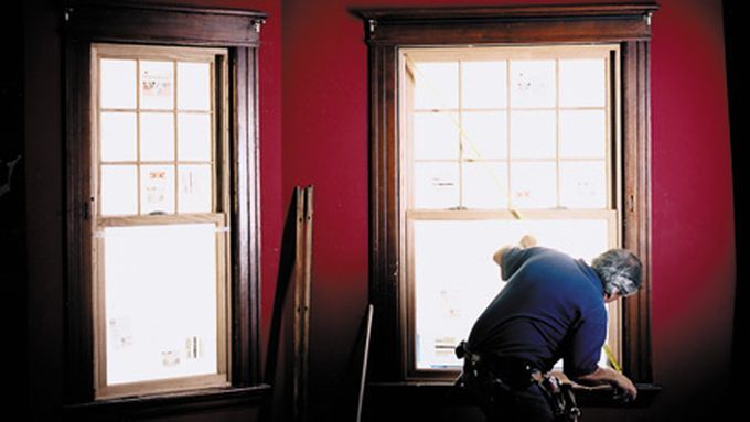 A man measuring angles for a window sill.