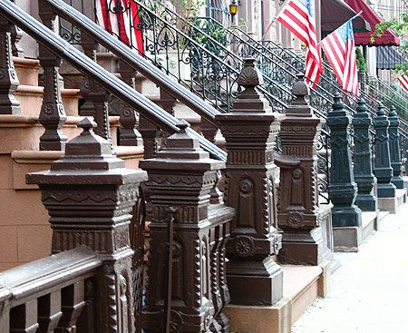 a line of newel posts down a sidewalk