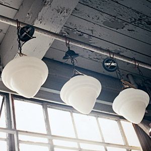 White vintage light fixtures hanging over a room.