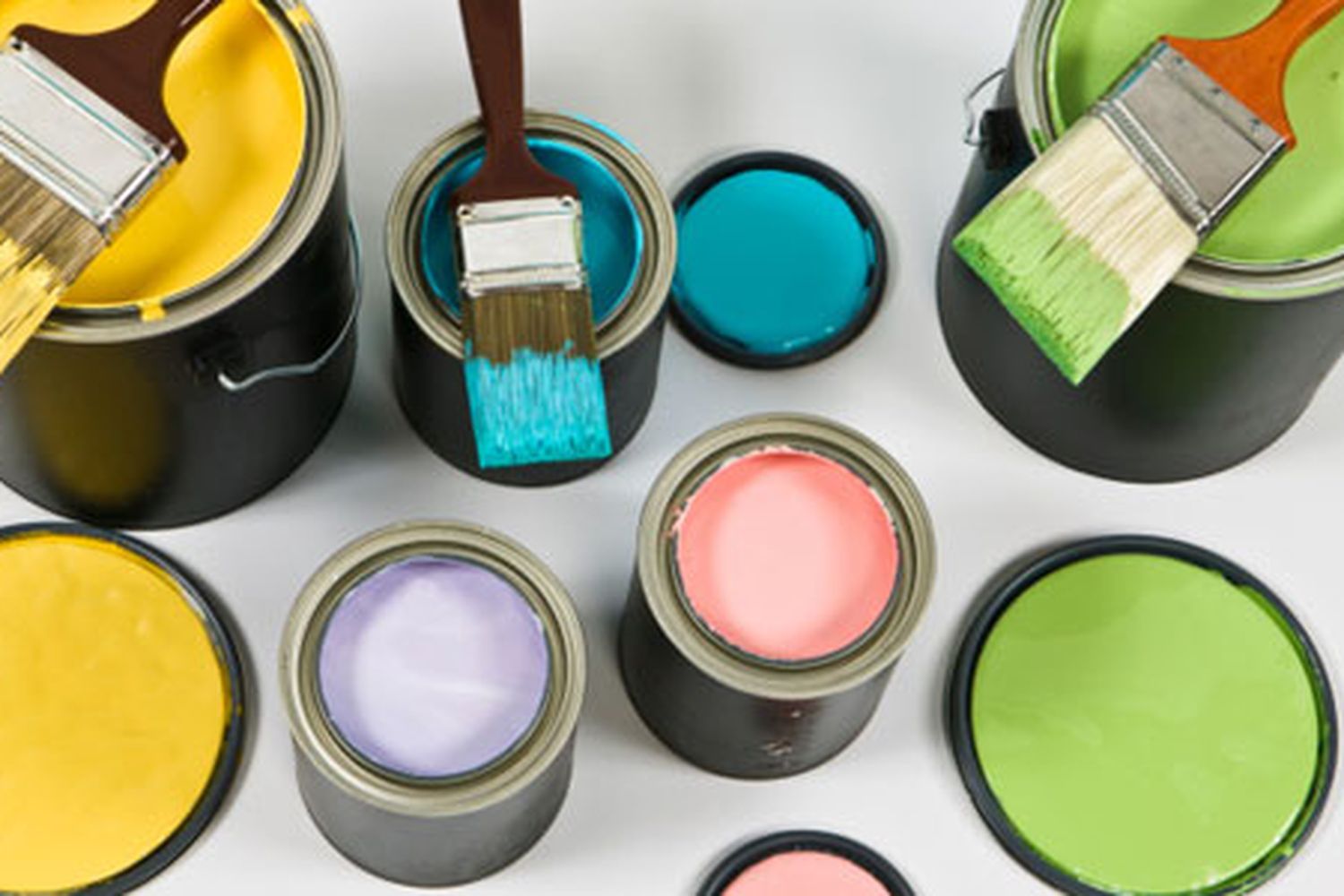A set of paint cans holding different colors of paint.