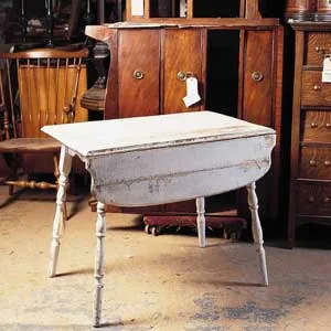 A table with aging and patchy white paint.