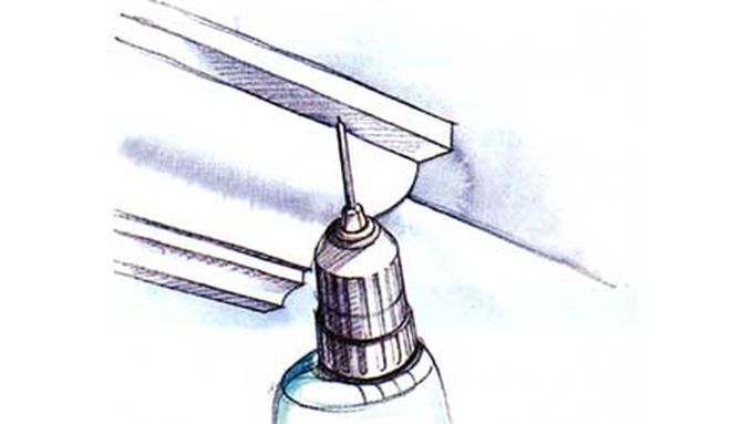 An illustration of a drill being used to make a pilot hole.