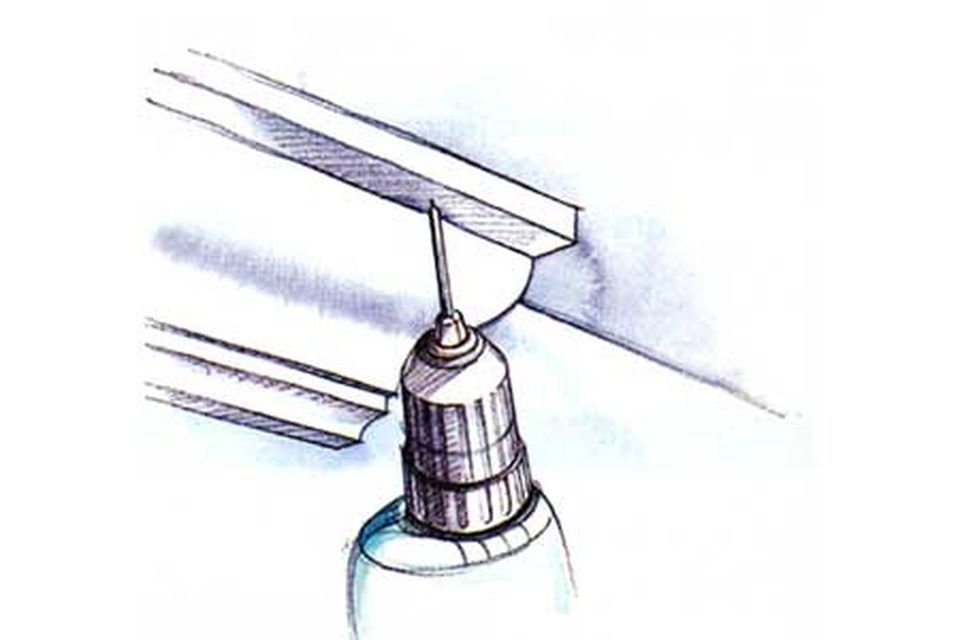 An illustration of a drill being used to make a pilot hole.
