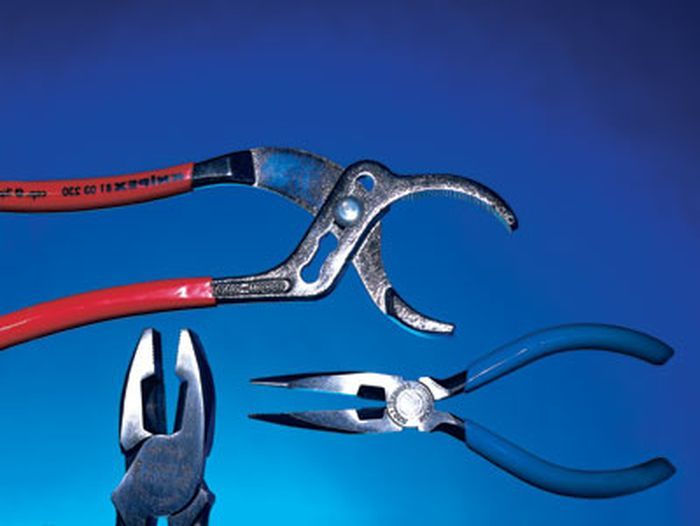 A set of three pliers on a blue background