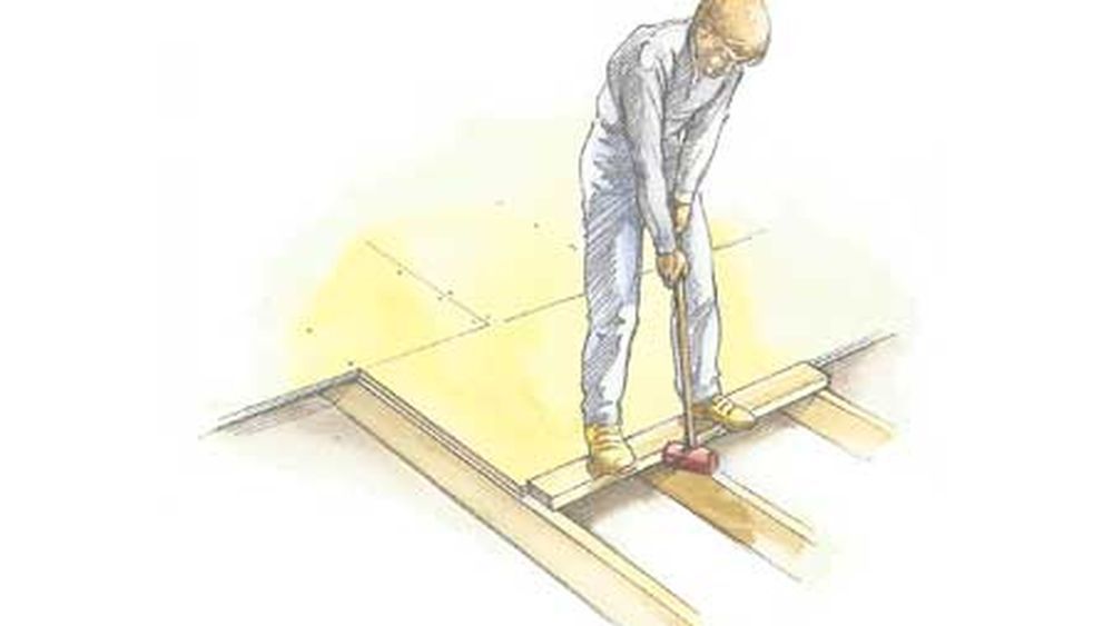 Drawing of a man using a mallet to install tongue-and-groove plywood.