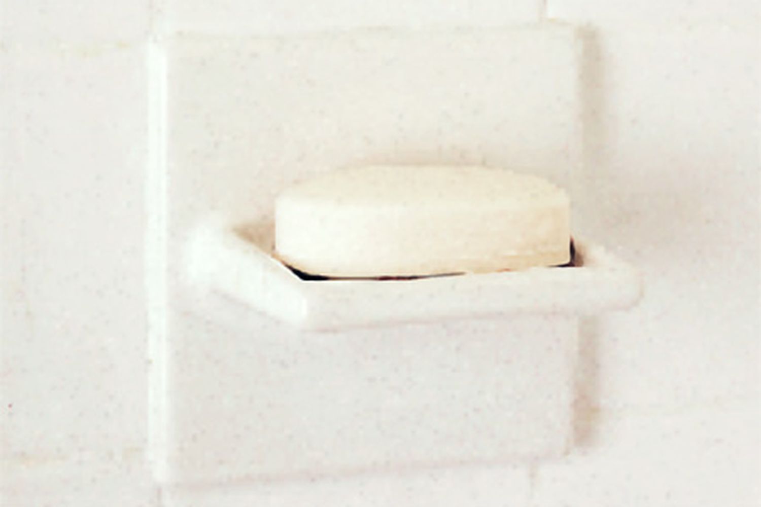 A soap dish with a bar of soap on it.